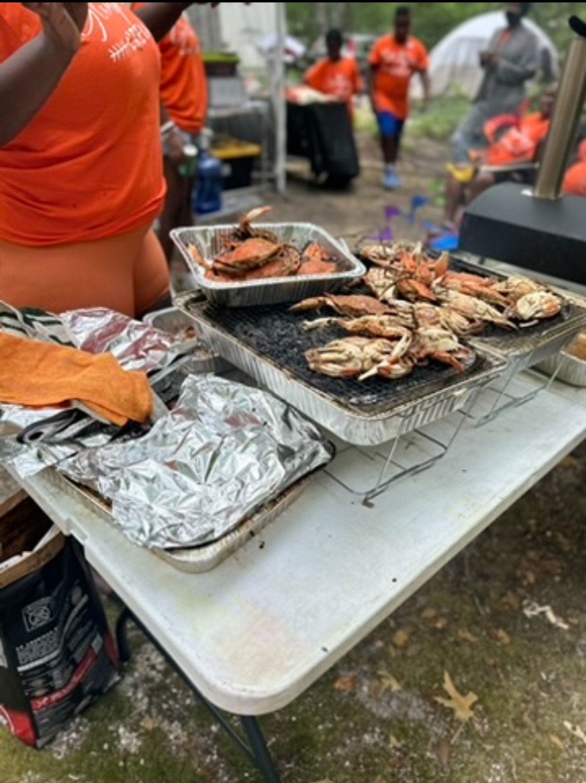 Crabs being grilled on an outdoor grill at the campsite